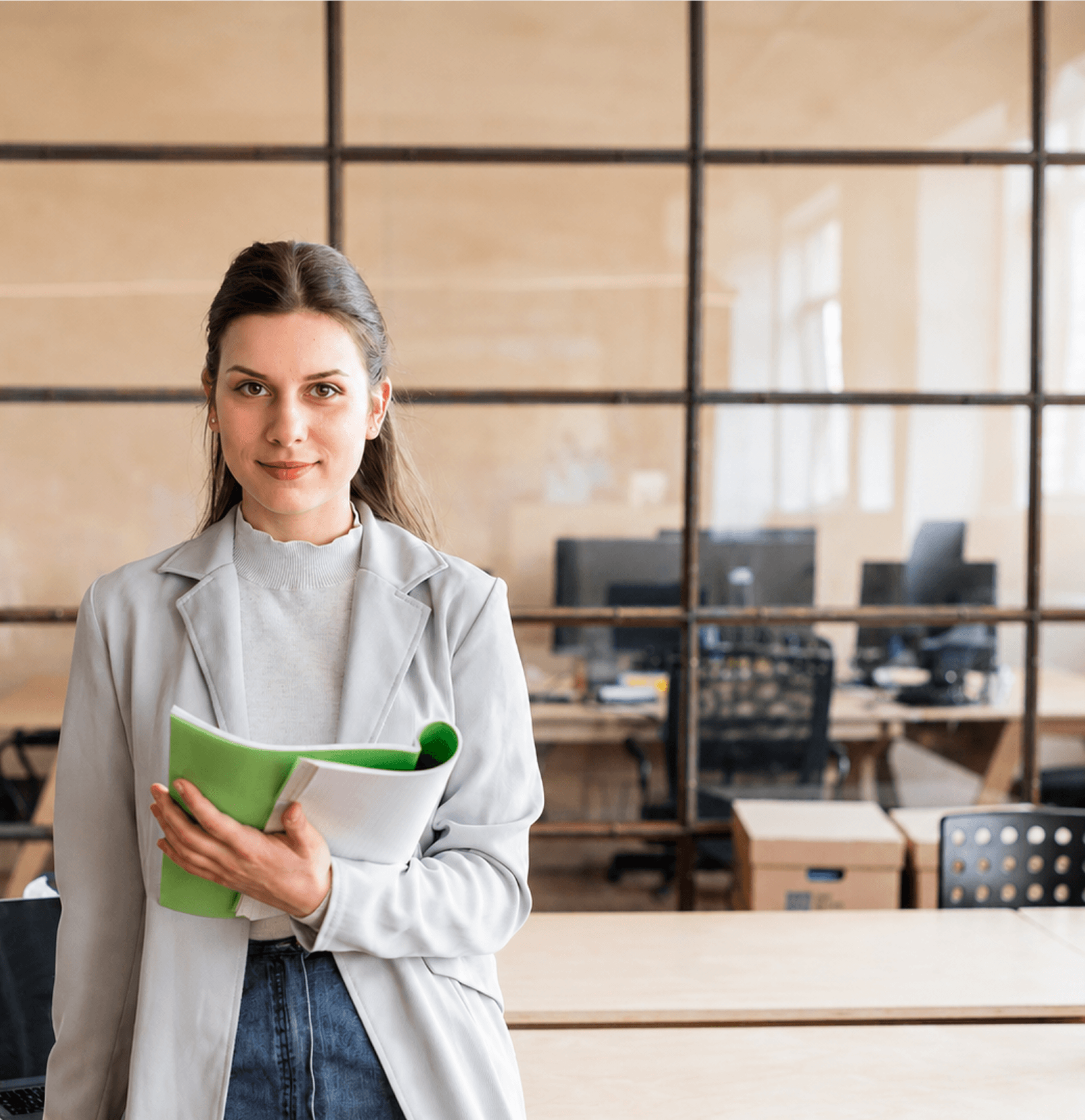 Professional woman holding a folder in a modern office